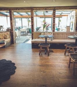 a restaurant with tables and chairs in a room at Mollösunds Wärdshus in Mollösund