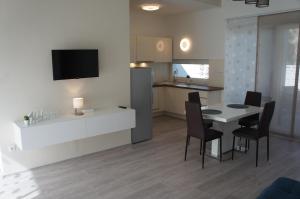 a kitchen and dining room with a table and chairs at Bori Villa Siófok in Siófok