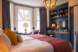 a bedroom with a large bed and a living room at The Canford in Poole
