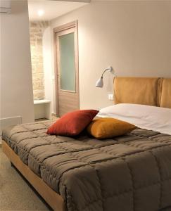 a bedroom with a bed with two pillows on it at LE GRAVINELLE in Ruvo di Puglia