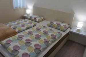 two beds in a room with two pillows on them at Bori Villa Siófok in Siófok +29 photos