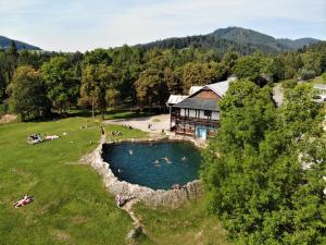 an aerial view of a lodge with people swimming in a pool at Apartment PineWood *** in Vyšné Ružbachy