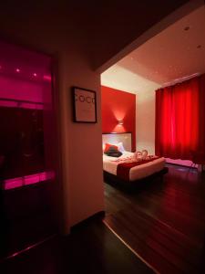 a bedroom with a bed and a red curtain at Chroma Exy - Chroma Italy in Rome