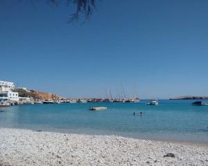 a view of a beach with boats in the water at Family house by the seaside of Karavostasis in Karavostasi