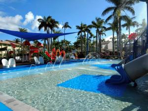 a swimming pool with a fountain in the water at Oasis Private 2 Bed Apartment in Caloundra