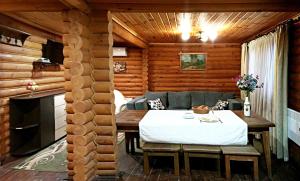 a room with a table in a log cabin at Котедж-парк Славна in Okhtyrka