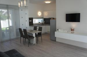 a kitchen and dining room with a table and chairs at Bori Villa Siófok in Siófok