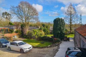 a white car parked in the driveway of a house at The Annex at Middle Filham, Ivybridge in Ivybridge