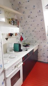 a kitchen with a white counter with drawings on the wall at Ferienwohnung Kochel mit Wallbox in Gifhorn