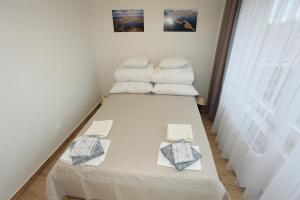 a large bed in a room with two pillows at Wigierski Park Narodowy in Suwałki