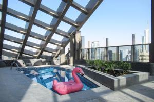 a swimming pool with a pink flamingo on a building at GuestReady - Gold by JBR Beach in Dubai