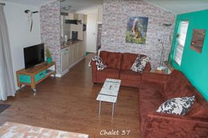 ein Wohnzimmer mit einem Sofa und einem Tisch in der Unterkunft dutchduochalet37 in s-Gravenzande