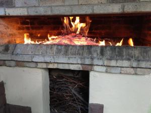 a brick oven with fire inside of it at Li Yes Yerevan hotel in Yerevan