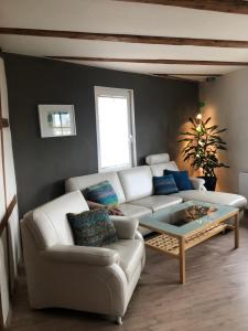 a living room with a white couch and a coffee table at Haus 1813 in Erfurt