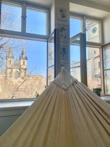 a hammock in front of a room with windows at Old Town Square Apartment in Prague