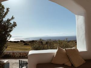 a white couch with a view of the ocean at Maisonette San Tosa in Aspro Chorio Paros