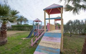 a playground with a slide in a park at Thapsus Beach Resort in Mahdia