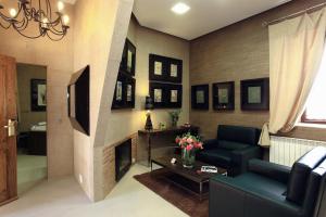 a living room with a couch and a fireplace at Hotel Boutique Palacio de la Serna in Ballesteros de Calatrava