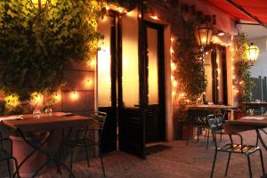 a restaurant with tables and chairs in front of a door at Hotel Ristorante Benigni in Campagnano di Roma