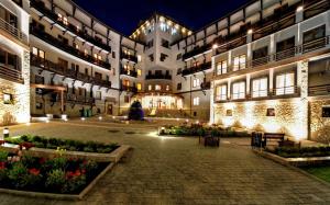 a courtyard of a building at night with lights at Apart-Hotel Chale Graal in Truskavets