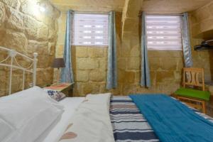 Ένα ή περισσότερα κρεβάτια σε δωμάτιο στο Ta' Frenc Farmhouse