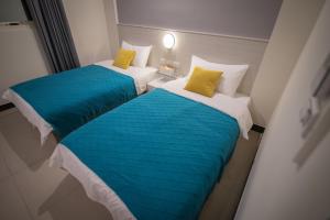 Giường trong phòng chung tại 漫時光 旅空間 ManLu INN