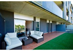 a living room with a couch and a chair on a building at UHC Paradise Village Family Complex in Salou