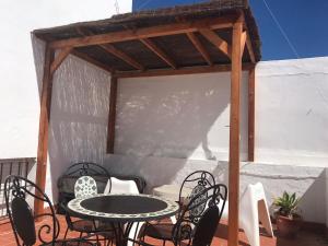 a gazebo with a table and chairs on a patio at DUPLEX TARIFEÑO in the OLD TOWN in Tarifa +8 photos