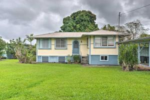 a yellow and blue house with a yard at Hilo Home Base - 3 Miles to State Park and Beach! in Hilo