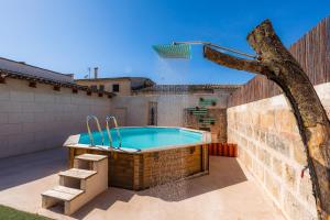 a swimming pool on the roof of a house at Cas Padri Pep in Ariany