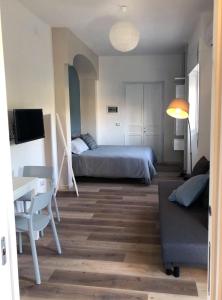 a bedroom with a bed and a table and a couch at CasaMarè in Taranto