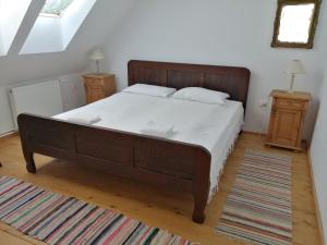 a bedroom with a large bed and two night stands at Vass Panzio in Zălan