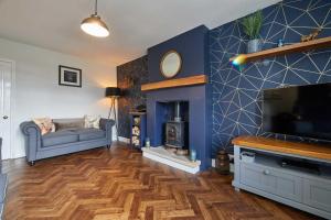 a living room with a couch and a television at Host & Stay - Cummins & Goings Cottage in Barnard Castle