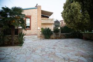 a stone patio in front of a house at Neriana Villa - Garden Paradise in Chania Town