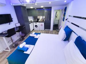 a large bedroom with a large bed and a kitchen at Mariandry Apartments in Larnaka