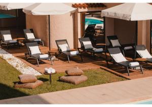 Blue Note Resort & Club في أثينا: مجموعة من الكراسي جالسة على سطح السفينة بجوار حمام السباحة