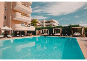 a large swimming pool in front of a building at Blue Note Resort & Club in Athens