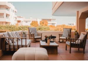a group of chairs and tables on a patio at Blue Note Resort & Club in Athens