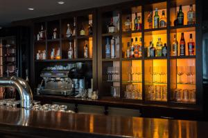 a bar with a lot of bottles of alcohol at Boston Hotel HH in Hamburg +38 photos