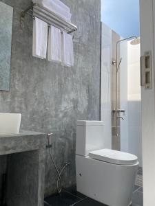 a bathroom with a toilet and a sink at Coral Castle - Goidhoo Maldives in Baa Atoll