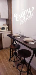 布拉索夫的住宿－SAVAS CLASIC BRASOV，厨房配有带2把椅子的桌子和微波炉