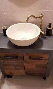 a white bowl sink on a counter with a faucet at SAVAS CLASIC BRASOV in Braşov