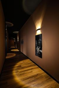 a hallway with a light on the wall at 24Seven Hotel Schwabach in Schwabach