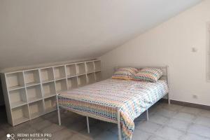 a bed with two pillows on it in a room at Casevielle le haut in Tulette