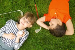two young children laying on the grass at Clayton Hotel & Leisure Club Sligo in Sligo