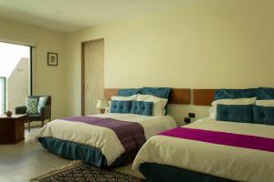 Postel nebo postele na pokoji v ubytování Hotel Nak'An Secreto Maya