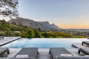 a swimming pool with a view of the mountains at Villa Lion View Private Luxury Retreat in Cape Town