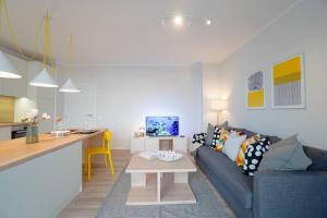 a living room with a blue couch and a table at Scandinavian Airy APT in Business Area & Airport in Sofia