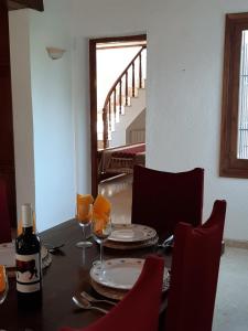 a table with plates and glasses and a bottle of wine at Villa Limon - Tropical Oasis with Private Pool in Jávea +36 photos