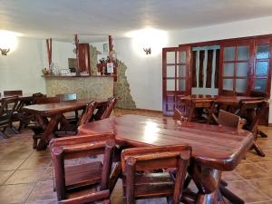 a dining room with wooden tables and chairs at Raza Soarelui in Moieciu de Sus